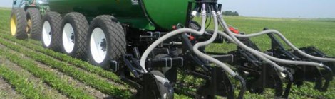 Fertilizer injector vehicle working on cropland.
